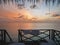 Relaxing view of open sea at dawn from Maldives resort`s water bungalow room window.