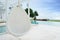 Relaxing white rattan hanging chair at swimming pool on sea view