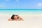 Relaxing woman on beach vacation sleeping on sand