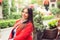 Relaxing woman sitting outside comfortable on a terrace balcony. Resting beautiful young multicultural asian indian caucasian girl