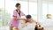 Relaxing young Asian woman lying down and closing her eyes on massage beds while receiving a massage from a therapist.