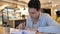 Relaxing Young Man Reading Book in Cafe