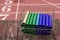 Relay batons in a medal basket on a deck looking over the track