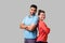 Reliable friendship. Cheerful young couple of friends in casual wear standing back to back. isolated on gray background