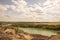 Relief clay mountains and a bright green lake