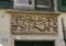 Relief of Saint George slaying the dragon above a door in Genoa, Italy