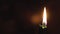 Religion, Christianity, Orthodoxy, holidays, cult concept - One single burning green candle against background of icon