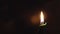 Religion, Christianity, Orthodoxy, holidays, cult concept - One single burning green candle against background of icon