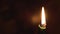 Religion, Christianity, Orthodoxy, holidays, cult concept - One single burning green candle against background of icon