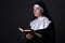 Religion concept - young beautiful woman nun reading bible over