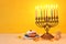 Religion image of jewish holiday Hanukkah background with menorah traditional candelabra, spinning top, chocolate coins and