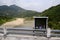 Religious box with incense sticks along a road on a bridge