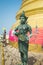 Religious bronze statue at the top of Golden Mountain in Famous Wat Saket Golden Mount in Bangkok,Thailand