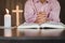 Religious Christian Child  praying over Bible indoors, Religious concepts