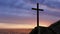 Religious christian cross standing on rock in the sea