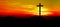 Religious grief landscape background banner panorama - View with black silhouette of mountains, hills, forest and cross / summit