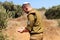 Religious Israeli soldier with a kippah on his head holds the Tanakh (Hebrew Bible) in his hands