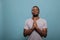 Religious man holding hands in prayer sign to worship God