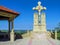 Religious monument - Cross with crucifixion of Jesus near highway. Nearby there is gazebo for rest and prayer.