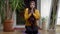 Religious Muslim woman praying sitting at home in the evening. Front view portrait of concentrated confident young lady