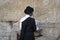 Religious orthodox praying at the Western wall in Jerusalem old city