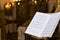 Religious song book and the church altar in background