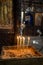 Religious spiritual concept. Candles in a tray with sand on the background of icons