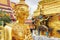 Religious statue with weathered gold leaf at the Grand Palace in Bangkok, Thailand