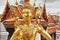 Religious statue with weathered gold leaf at the Grand Palace in Bangkok, Thailand