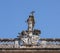 Religious stone statue on top of one building