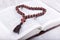 Religious theme holy book and cross on a white wooden background