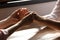 Religious women holding hands and praying together at wooden table, closeup