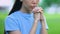 Religious young female praying to God in park, hoping for help, life problems