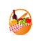 A relish wicker picnic basket with a bottle of red wine, fruit and cheese.