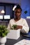 Relocated african american businesswoman putting objects in cardboard box