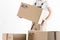 Relocation services concept. Mover holding cardboard box isolated on white background. Loader in uniform carrying moving box.