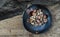 The remaining chestnuts in black ceramic plate on old rustic wooden background