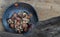 The remaining chestnuts in black ceramic plate on old rustic wooden background