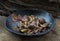 The remaining chestnuts in black ceramic plate on old rustic wooden background