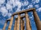 Remaining columns of Temple of Olympian Zeus in Athens, Greece shot against blue sky and picturesque clouds