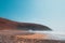 Remaining red sandstone stone arch in Legzira Beach. Rugged coastline in Tiznit Province of Morocco, Africa. Atlantic Ocean waves