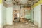 Remains of abandoned damaged and destroyed house interior by grenade shelling with collapsed roof and wall in the war zone selecti