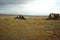 The remains of an ancient stone sanctuary in the arid autumn steppe under thunderclouds