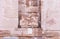 The remains of a bas-relief in a niche in the ruins of Roman Temple in Petra. Near Wadi Musa city in Jordan