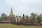 Remains of base & pillars of Wat Chang Lom`s viharn assembly hall, with its distinctive bell shaped stupa surrounded by elephants
