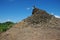 The remains of a broken pagoda on top of a hill being reclaimed by nature in Mrauk U, Myanmar