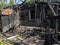 The remains of a burned wooden house. Abandoned home