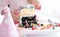 Remains of chocolate and vanilla cake and colorful butter cream on stand. Leftover birthday cake and sugar candies on table after