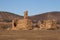 Remains of a derelict homestead with hills in background