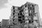 The remains of a destroyed concrete building against the sky. Black and white. Background